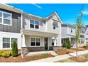 Attractive two-story townhome with a welcoming porch and neatly landscaped front yard on a clear, sunny day at 5850 Strathmore Ct, Charlotte, NC 28215