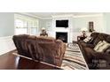 Inviting living room with plush seating, a fireplace, and a mounted TV at 7928 Ponderosa Pine Ln, Charlotte, NC 28215