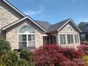 Stylish home exterior with stone accents, arched windows, and manicured landscaping at 811 Wynnshire Dr # A, Hickory, NC 28601