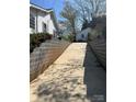 Unique driveway featuring concrete retaining walls leading up to the home and garage at 818 N 4Th St, Albemarle, NC 28001