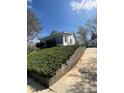 A charming home is perched atop a retaining wall with a beautiful, grassy landscape at 818 N 4Th St, Albemarle, NC 28001