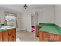 Vintage kitchen with light wood cabinetry, green countertops, and a classic design at 106 Courtland St, Chester, SC 29706