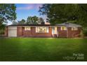 Charming brick home with lush front lawn and mature trees at 1099 S Potter Rd, Lancaster, SC 29720