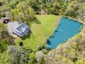 Stunning aerial view of estate featuring a large pond, manicured lawn and a beautiful home nestled among the trees at 1151 Trull Hinson Rd, Wingate, NC 28174