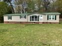 Attractive single story home with green shutters and freshly mowed lawn at 13079 Philadelphia Church Rd, Oakboro, NC 28129