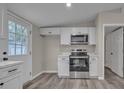 Modern kitchen featuring stainless steel appliances and white cabinetry with contemporary hardware at 132 Riverview Acres Ln, Taylorsville, NC 28681