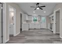 Bright kitchen with white cabinets, stainless steel appliances, and stylish gray flooring at 132 Riverview Acres Ln, Taylorsville, NC 28681