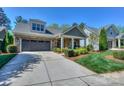 Beautiful exterior featuring stone accents, a gray garage door and well-maintained landscaping at 14917 Dewpoint Pl, Huntersville, NC 28078
