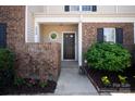 Close up of the entryway of the townhome, showing a small brick wall at 1518 Sylvia Ct, Charlotte, NC 28205