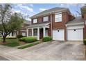 Beautiful two-story brick home featuring a front porch and attached two-car garage at 20015 N Cove Rd, Cornelius, NC 28031