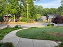 Quiet street view featuring mature trees, sidewalks and well-maintained lawns of the neighborhood homes at 217 Windsor Dr, Shelby, NC 28150