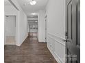 Inviting hallway with wood floors and white wainscoting leads to a bright, open living space at 224 Old Harbor Dr, Mount Gilead, NC 27306