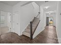 Carpeted stairs with white railing and dark wood accents lead to the upper level at 224 Old Harbor Dr, Mount Gilead, NC 27306
