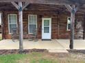 Charming covered porch with rocking chairs, a rustic door and interesting decorative touches at 291 Love Valley Rd, Statesville, NC 28625