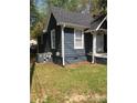 Charming single-story home with grey siding, white trim, and well-maintained lawn at 401 Plymouth St, Kannapolis, NC 28083