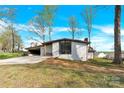 A beautifully landscaped single-story home with a spacious driveway and large modern windows at 403 Greenbriar S Rd, Statesville, NC 28625
