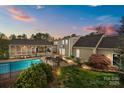 A private backyard oasis with a sparkling pool, covered patio, and ample space for outdoor entertaining at 405 Downing Dr, Kings Mountain, NC 28086