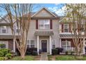 Charming townhome featuring neutral siding, red shutters, and a cozy front porch perfect for relaxing at 4517 Sabin St, Rock Hill, SC 29732