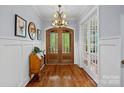 Grand foyer with hardwood floors, chandelier, and elegant french doors at 4637 Gold Finch Dr, Denver, NC 28037