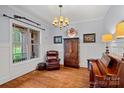 Cozy living room featuring hardwood floors, a leather chair, and natural light at 4637 Gold Finch Dr, Denver, NC 28037