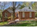 Charming brick home with a well-manicured lawn and mature trees creating a welcoming curb appeal at 481 Patriot Ne Ct, Concord, NC 28025