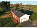 Exterior shot highlighting the brick, attached garage, and solar panels of this property at 5373 Nc Hwy 16 N Hwy, Taylorsville, NC 28681