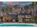 Expansive backyard featuring a refreshing swimming pool and lovely screened-in porch for outdoor relaxation at 5750 Hemby Rd, Matthews, NC 28104