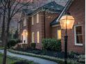 Well-maintained brick home featuring manicured landscaping and an inviting entryway with a decorative lantern at 5750 Hemby Rd, Matthews, NC 28104