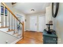 View of the foyer with hardwood floors, staircase with white risers and light wood handrail at 608 Grace St, Shelby, NC 28150