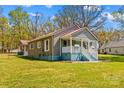 A cozy home with a covered porch, fresh exterior paint and well-maintained lawn at 612 Rowan Mill Rd, Salisbury, NC 28147