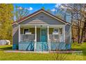 A cozy home with a covered porch, landscaped yard, and charming curb appeal at 612 Rowan Mill Rd, Salisbury, NC 28147