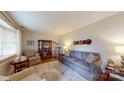 Bright living room with hardwood floors, bay window, comfortable seating, and decorative accents at 7626 Surreywood Pl, Charlotte, NC 28270
