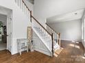 Bright foyer with hardwood floors and a staircase, creating a grand entrance and open feel at 7822 Noland Woods Dr, Charlotte, NC 28277
