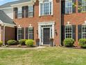 Close up showing a front door with black shutters and flower pots, adding a touch of elegance to the facade at 7822 Noland Woods Dr, Charlotte, NC 28277