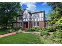 Inviting Tudor-style home with landscaped front yard, brick facade, and well-maintained greenery at 801 Berkeley Ave, Charlotte, NC 28203