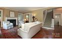 Comfortable living room featuring hardwood floors, fireplace, and adjacent room with glass doors at 801 Berkeley Ave, Charlotte, NC 28203