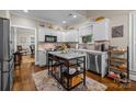 Well-lit kitchen featuring white cabinetry, stainless appliances, and a stylish center island with marble countertop at 801 Celbridge Ct, Charlotte, NC 28270
