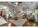 Open living room featuring hardwood floors, neutral decor, and seamless access to the kitchen and dining areas at 801 Celbridge Ct, Charlotte, NC 28270