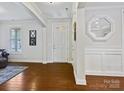 Inviting foyer featuring hardwood floors, neutral paint, a stylish mirror and bright natural light at 8618 Whitehawk Hill Rd, Waxhaw, NC 28173