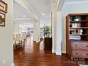 Open-concept living area with hardwood floors and elegant archways leading to the dining and living spaces at 8618 Whitehawk Hill Rd, Waxhaw, NC 28173