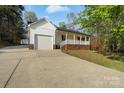 Ranch style home with attached garage and a long driveway at 902 Cornelius Rd, Mooresville, NC 28117