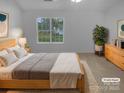 Cozy bedroom features a comfortable bed, neutral tones, and serene window view, virtually staged at 9930 Birch Knoll Ct, Charlotte, NC 28213