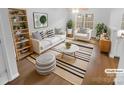 Staged living room with modern decor, including a plush sofa, stylish rug, and ample natural light at 9930 Birch Knoll Ct, Charlotte, NC 28213