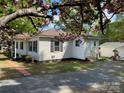 Charming home exterior with spring blossoms, walkway, and detached garage at 109 Barrett Rd, Cherryville, NC 28021