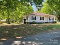 Side view of traditional home with mature trees, tidy lawn, and attractive landscape at 109 Barrett Rd, Cherryville, NC 28021