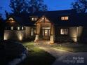 Stunning exterior view of a well-lit home with stone accents and landscaped pathway at 111 Milledge Dr, Mooresville, NC 28117