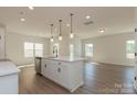 Open concept kitchen with stainless steel appliances and a modern island overlooking the living area at 1121 Red River Dr, Salisbury, NC 28144