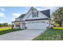 Beautiful exterior of a home with a white finish, black roof, and a two-car garage at 120 Southern Oaks Ln, Salisbury, NC 28147