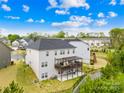 A two-story home featuring a deck and covered patio enhances the backyard space at 12305 Stinson Ct, Charlotte, NC 28277