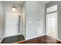 Inviting entryway featuring tile flooring, coat closet, and a front door with sidelight at 13417 Krislyn Woods Pl, Charlotte, NC 28278
